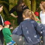 Kids hunt through woodland for bugs and litter