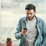 Man looking at message on phone