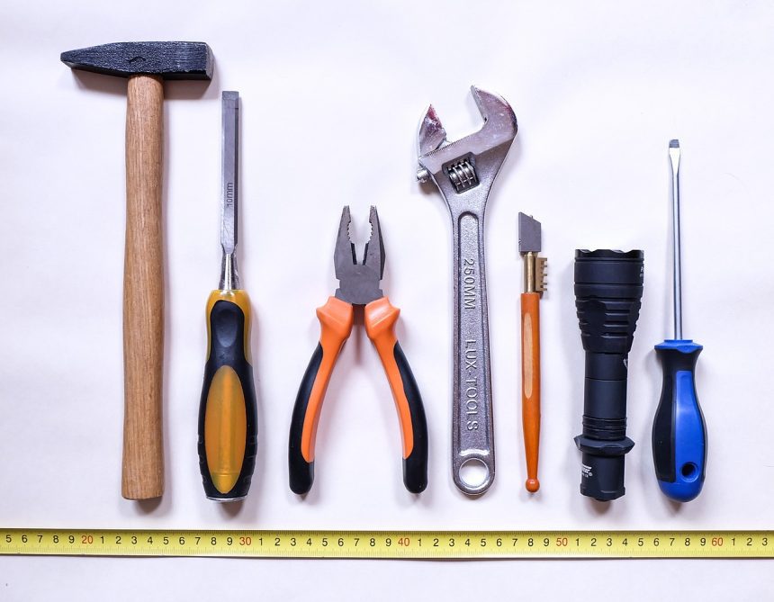 Various tools lined up over a measuring tape