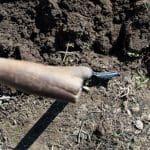 Spade dug into soil (view of spade handle from above)