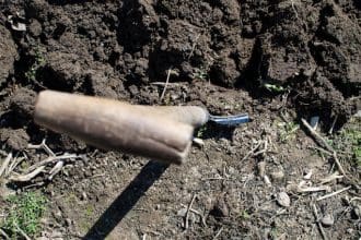 Spade dug into soil (view of spade handle from above)