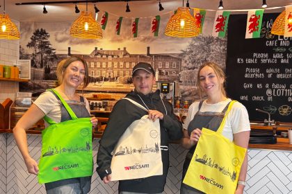 This is Wrecsam and Lot 11 tourim initiative - image shows Lot 11 owner Sarah Baker with artist Mikey Jones and Lot 11 staff member Beth Williams