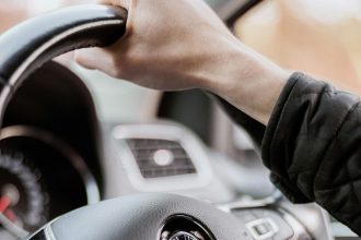 Hand on steering wheel