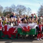 Group of children holding a St David's Day flag