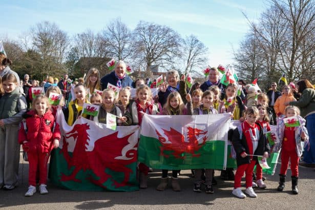 Group of children holding a St David's Day flag