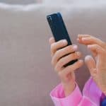 A person’s hands holding a smartphone