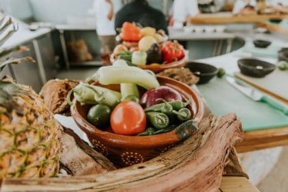 Foods including pineapple, tomato and peppers on a worktop at a food workshop
