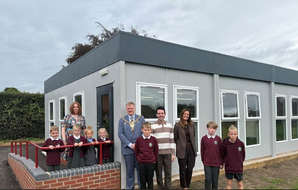 Staff and pupils gather with the Mayor outside the new All Saints Library